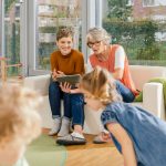 pre-school-teachers-with-tablet-looking-at-children-in-kindergarten.jpg