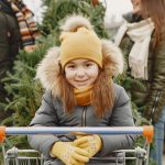 Winter concept. People in a Christmas market. Family with cute daughter.