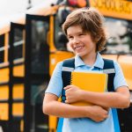 young-caucasian-schoolboy-kid-pupil-student-holding-copybooks-and-books-preparing-for-school.jpg