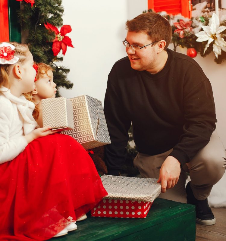 handsome father with daughter in studio with New Year's decor